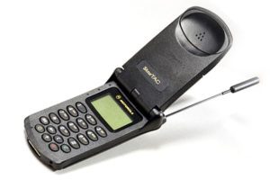 A old flip phone, it has a keypad and an antenna